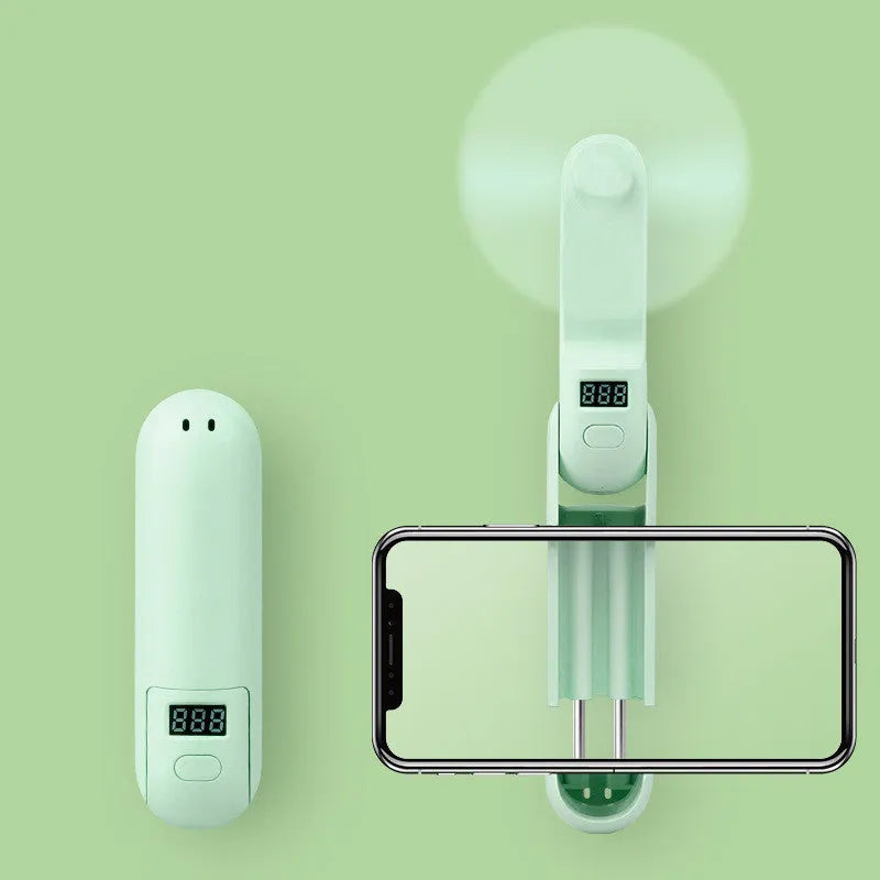 Folding mini personal desk fan showing three plastic blades and compact housing