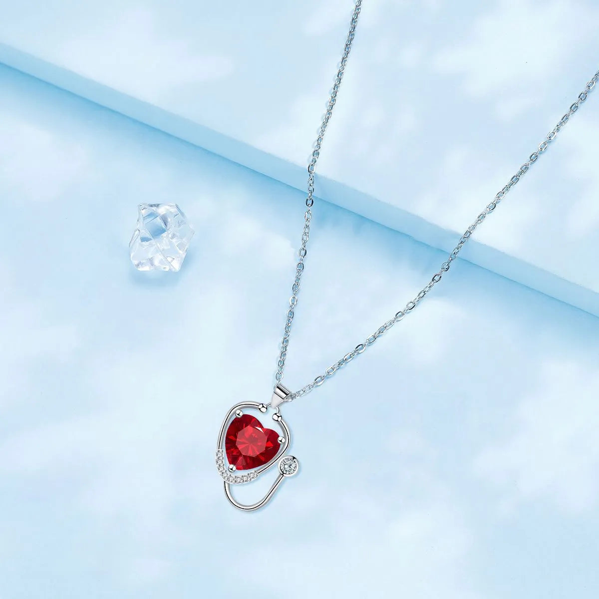 Copper stethoscope necklace for women with red diamond wing pendant on a long chain