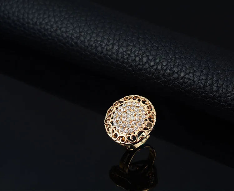 Gold jewellery four piece set with necklace, earrings, ring, and hand accessories featuring alloy and artificial gems
