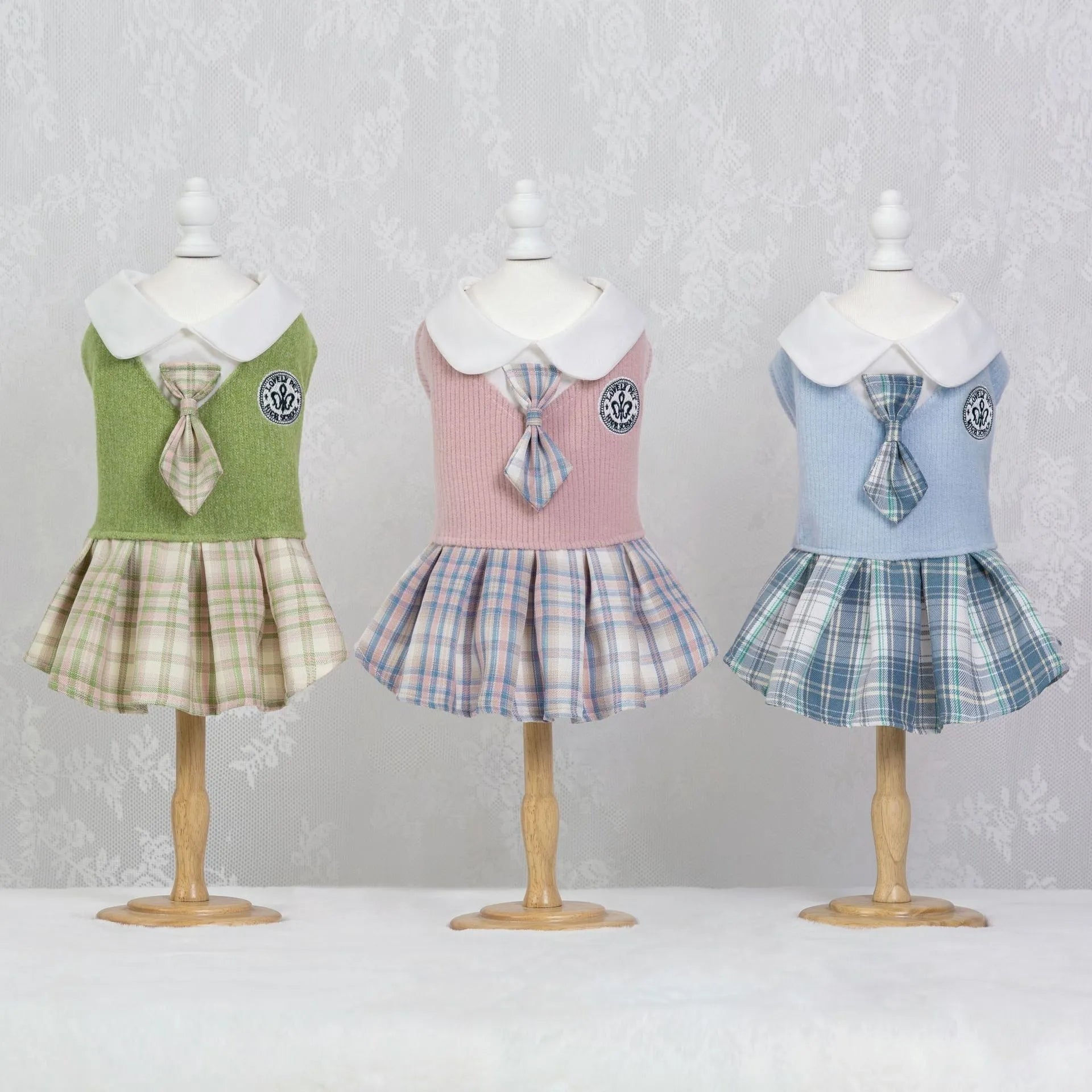 A pink tartan skirt for small dogs and cats with an adjustable velcro waist closure.