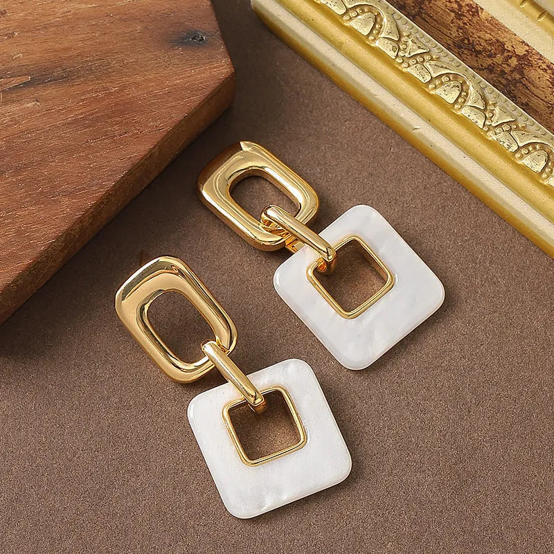 Copper hollow geometric square earrings with electroplated finish, chamfered corners, and two colour options