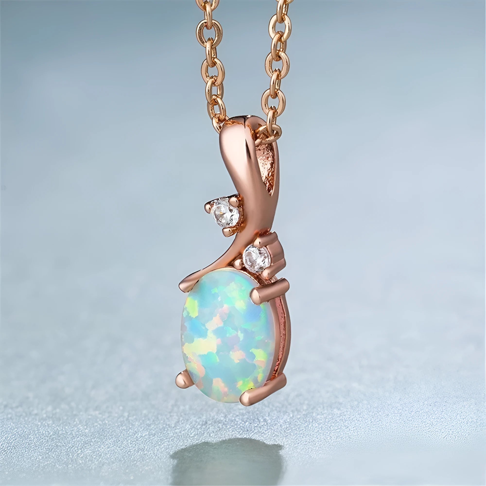 Water drop opal pendant necklace on an adjustable O-chain in rose gold or white.