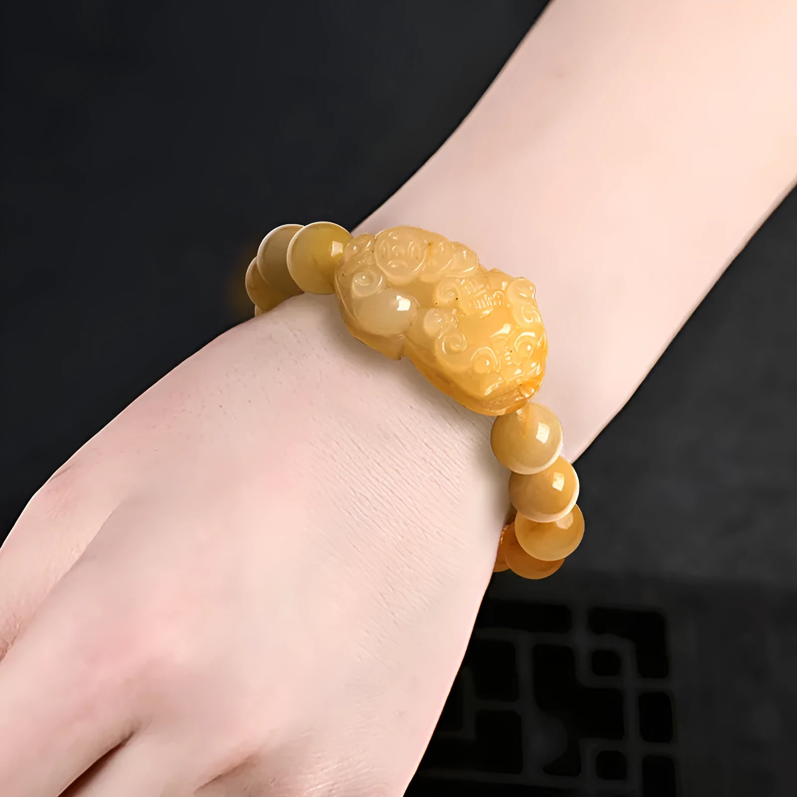 Golden Thread Jinsi Jade carved money bracelet showing pendant and beads, with size option examples.