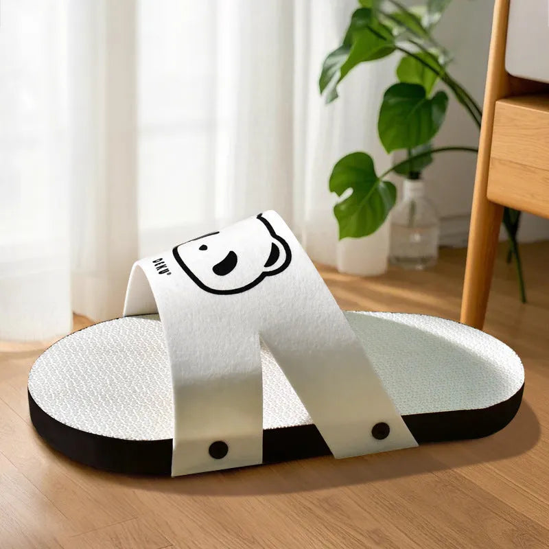 White corrugated paper cat scratch board with slipper design on flat surface