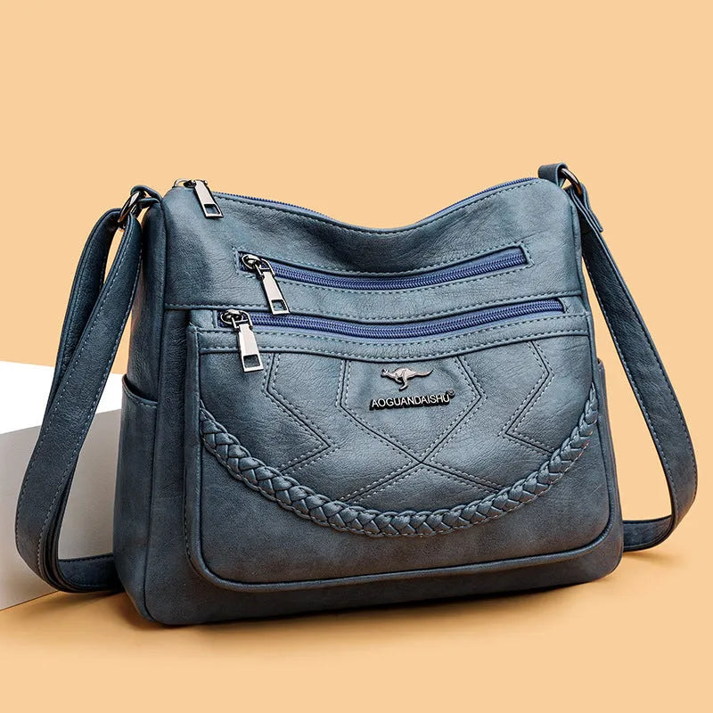 Soft PU leather shoulder bag in horizontal square shape with crossbody strap and multiple compartments