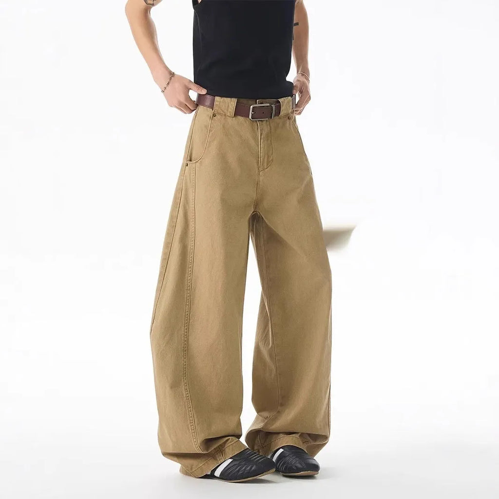 Brown men's loose-fit straight leg denim jeans with a button fly on a neutral background.
