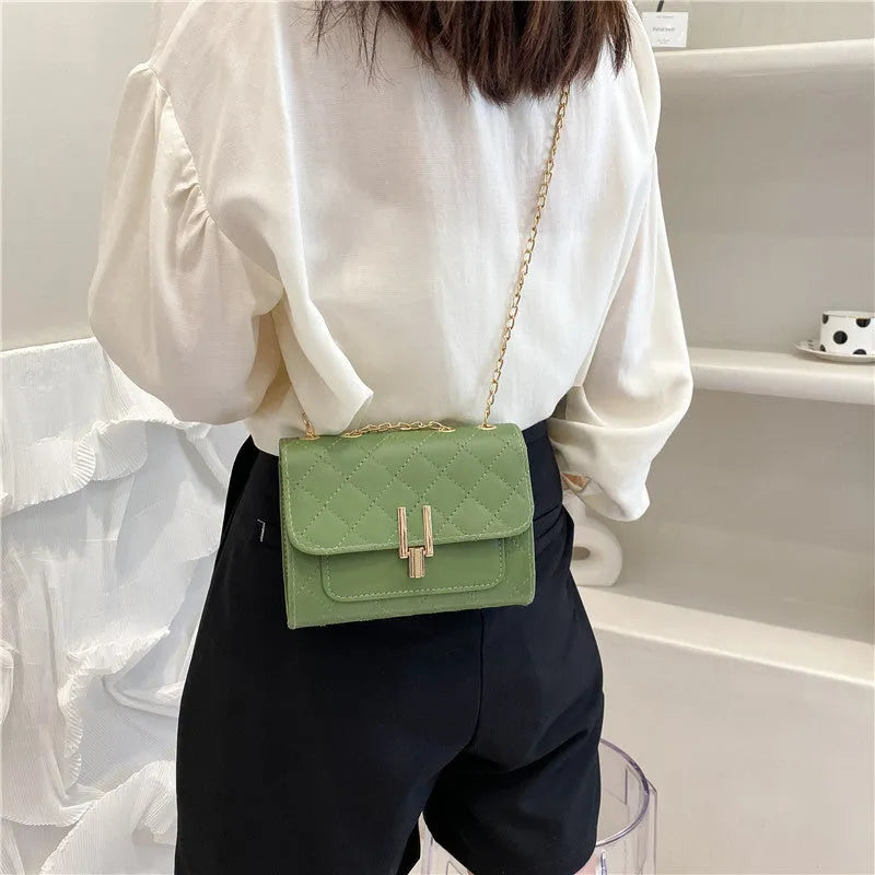 Women's diamond lattice chain crossbody bag in black, green or white with adjustable strap