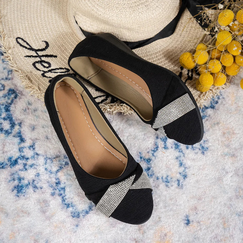 Black women's slip-on casual shoes with rhinestone details on the fabric upper and a chunky short heel.