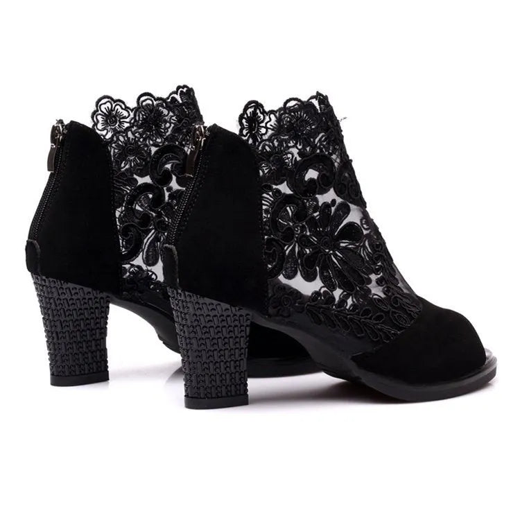 Black women's lace-up gladiator sandals with a square heel and zip fastener.