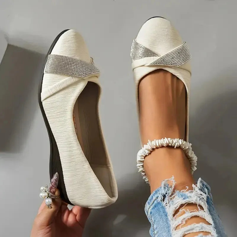 Black women's slip-on casual shoes with rhinestone details on the fabric upper and a chunky short heel.