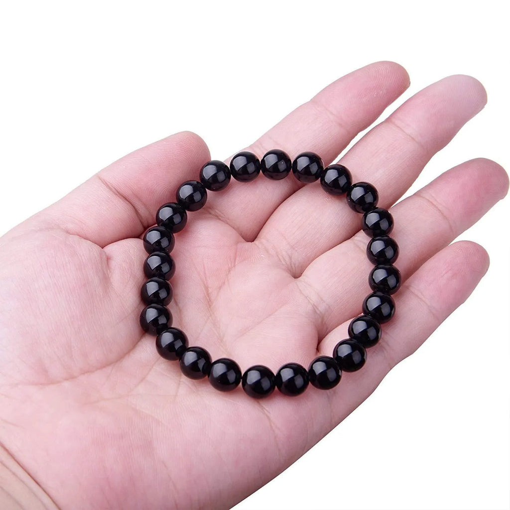 Black agate stretch bracelet with 8mm geometric beads on a black elastic cord.