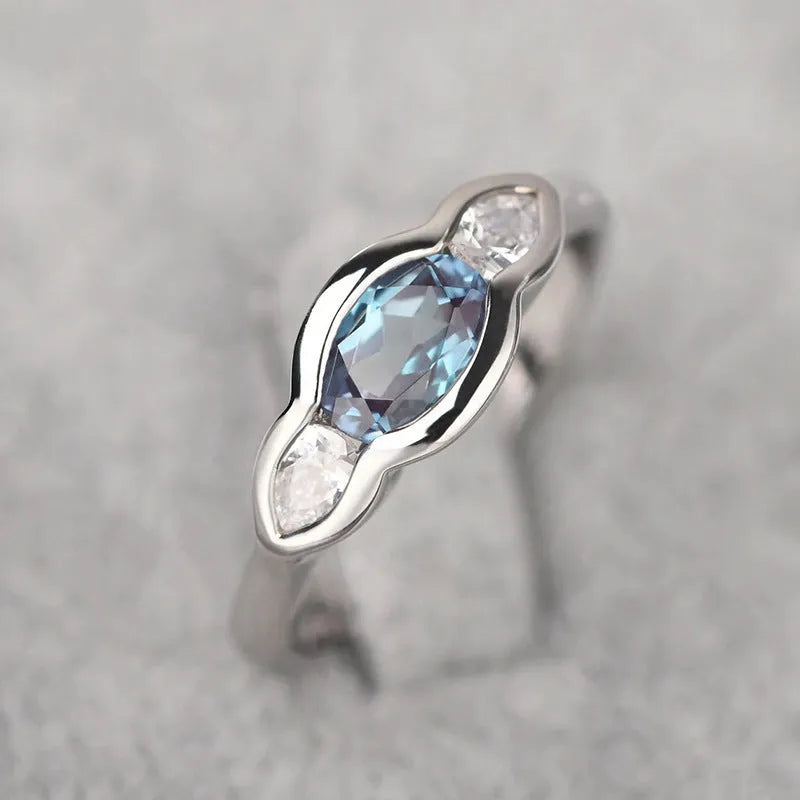 Geometric ellipse ring with inlaid zircon stones in white gold colour finish