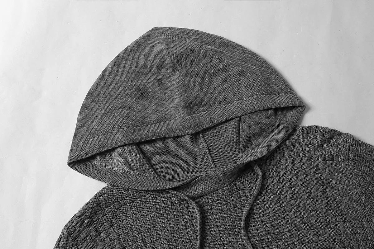 Men's black cotton polyester blend hooded sweater laid flat, showing the front design and hood.