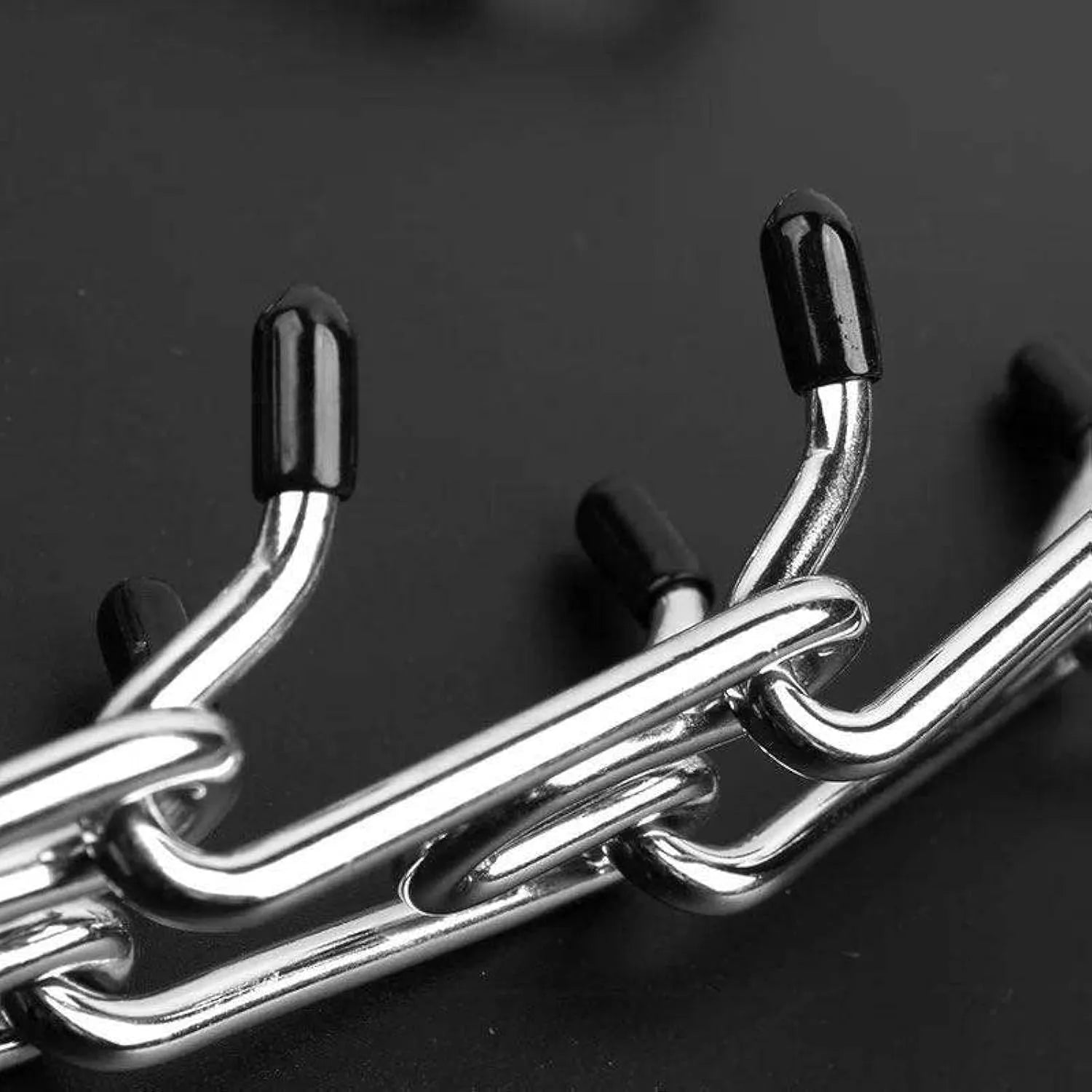 Stainless steel dog training pinch collar with adjustable links and black rubber tips on the prongs.