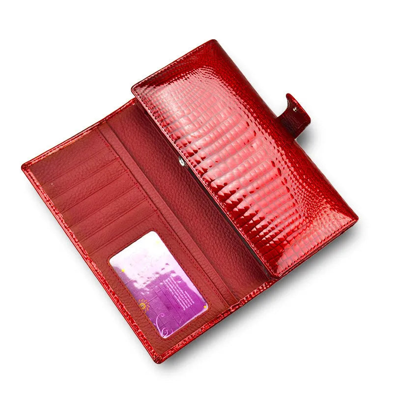 Women's patent leather coin purse with crocodile pattern in red colour showing pigskin lining interior