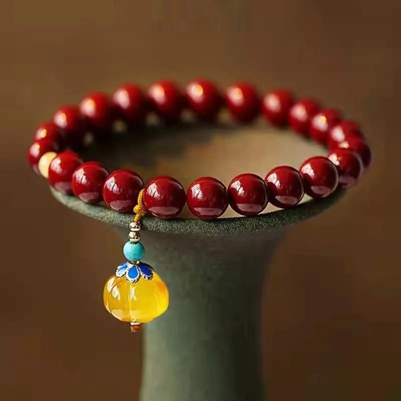 Gold cinnabar wave bracelet with copper bead on wrist, unisex national style