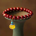Gold cinnabar wave bracelet with copper bead on wrist, unisex national style