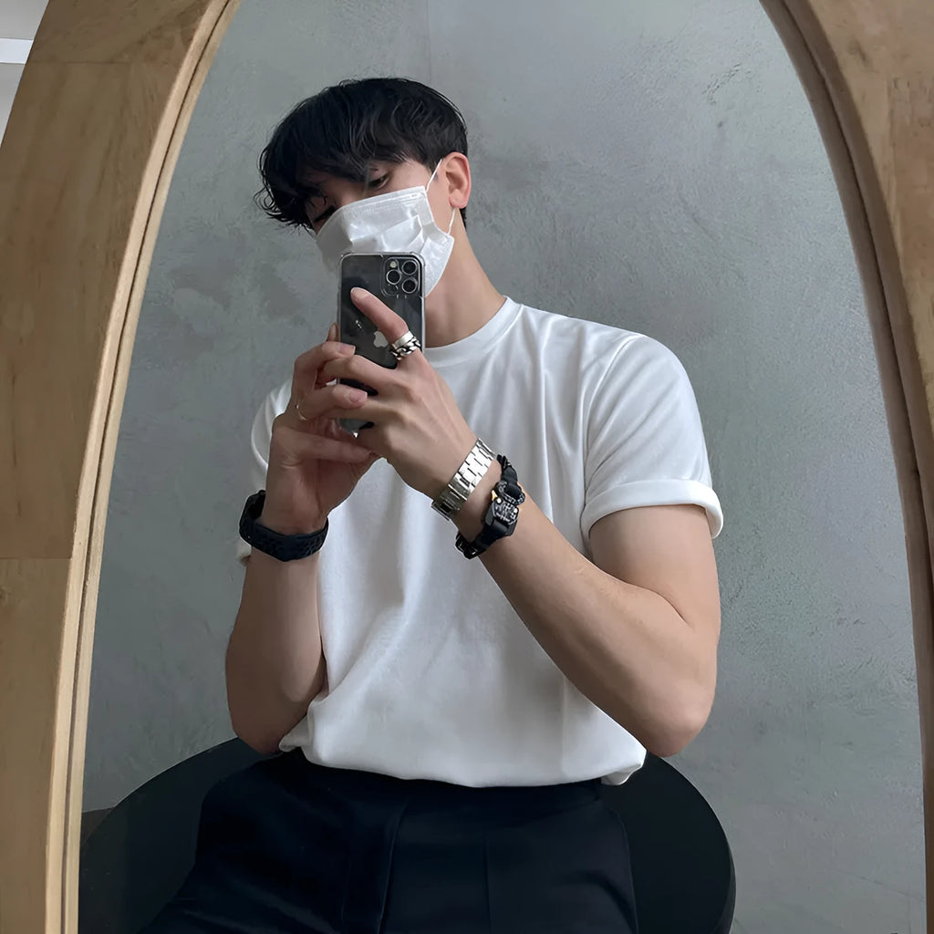 Mens slim fit cotton t-shirt in black on a hanger, showing round neck and half sleeves.