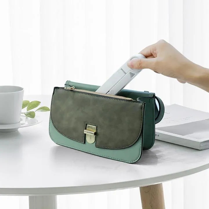 Black foldable tablet holder showing adjustable stand supporting smartphone in landscape orientation