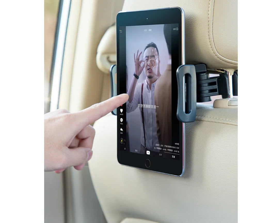 Black plastic car phone holder mounted on rear seat base holding a tablet for navigation