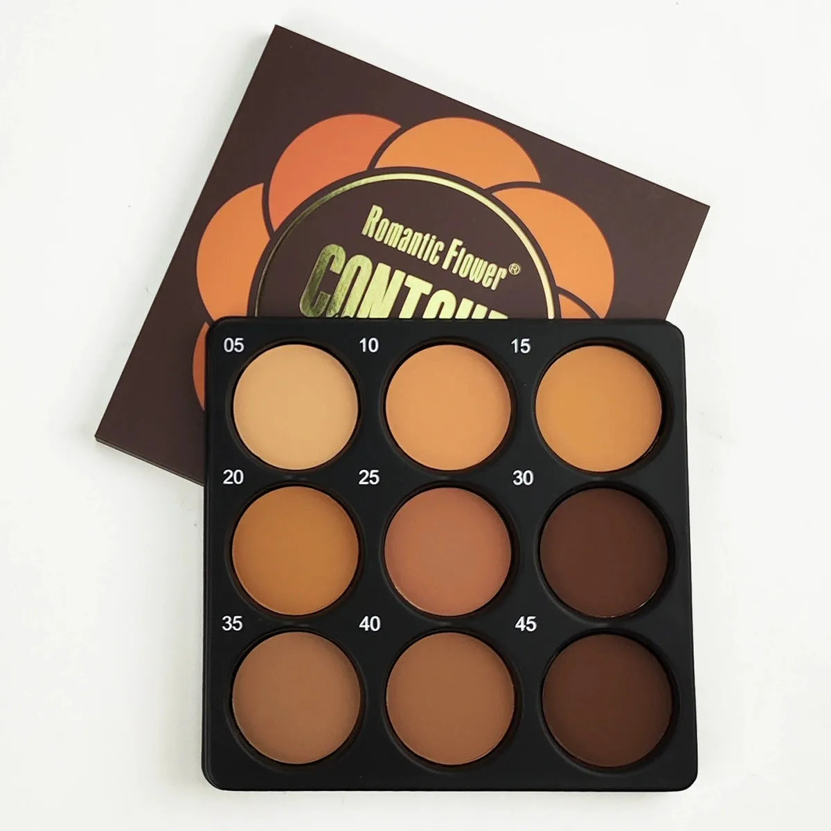 Dark matte makeup palette showing nine earthy colours with compact case and repair disk
