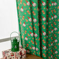 Green Christmas curtain with printed snowman and angel cartoon pattern, one metre wide.