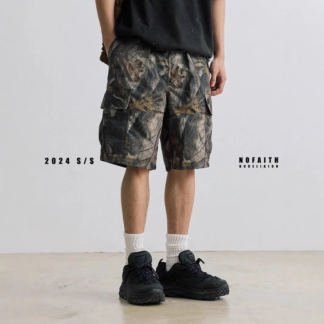 Men's loose fit straight-leg denim shorts in army green on a plain background.