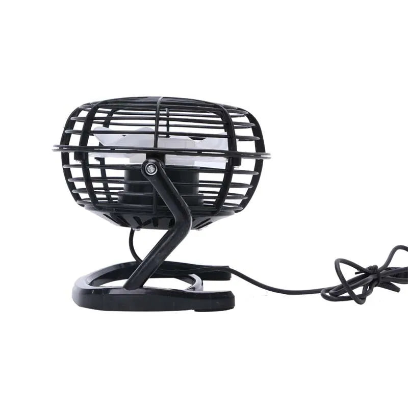 Mini adjustable USB desk fan in black on a desk next to a laptop