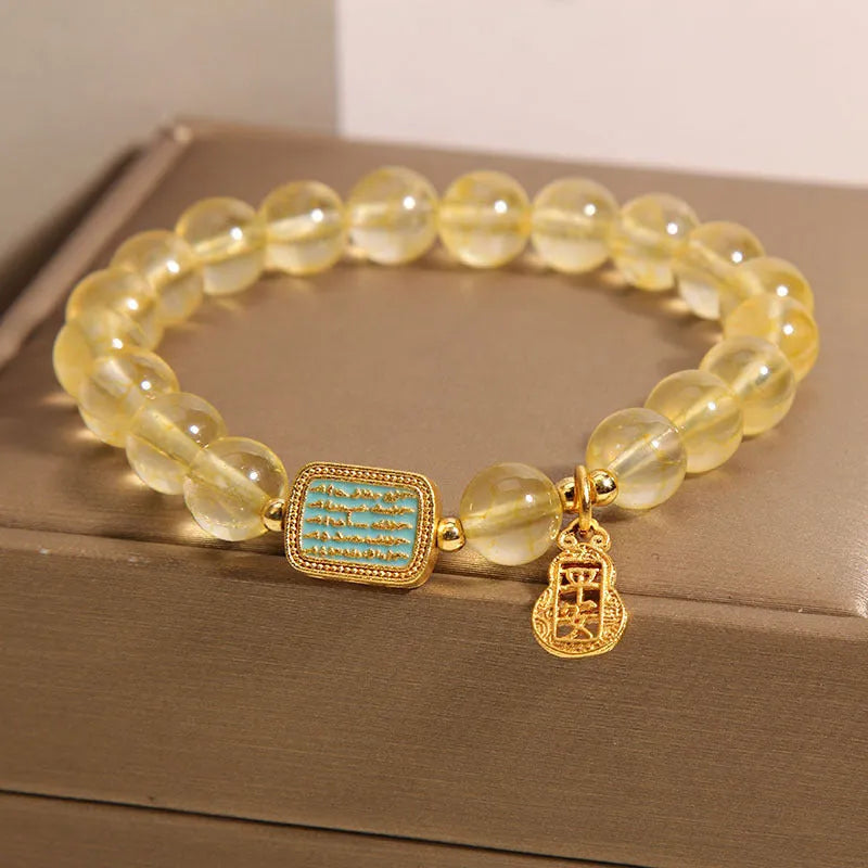 Natural citrine yellow crystal bracelet for women with rhinestone accents on a white background