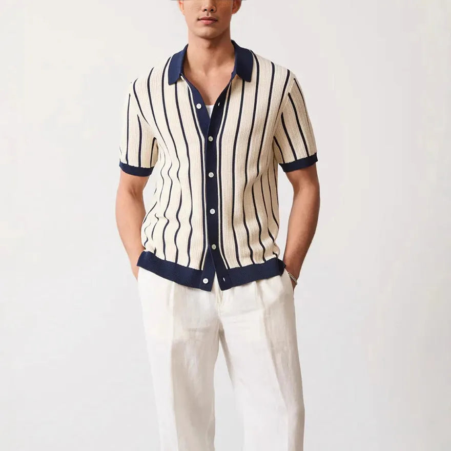 Man modelling a white short sleeve knitted top with asymmetric stripes and a lapel collar.