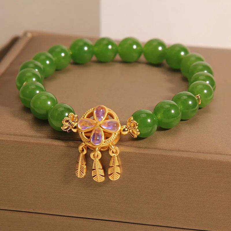 Women's green jasper crystal bracelet with four-leaf clover and dream catcher pendant, original design, on white background
