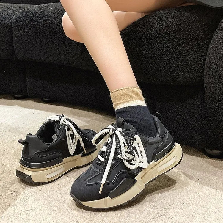 Retro platform sports shoes in black with round toe, front lace-up, rubber sole, and mesh lining