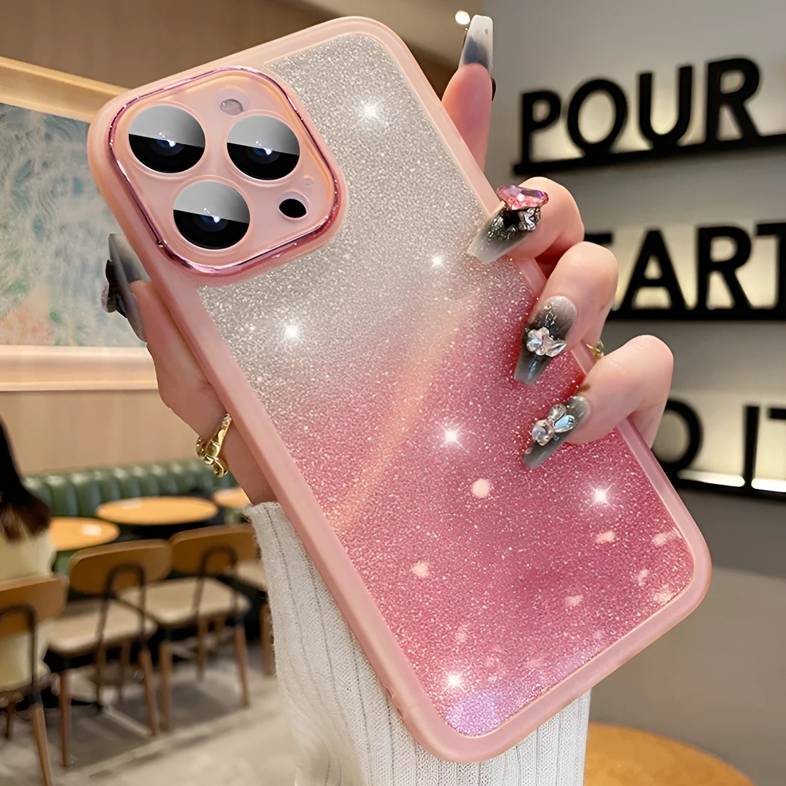 Transparent glitter iPhone case showing gradient pink and silver sparkle effect on TPU rubber