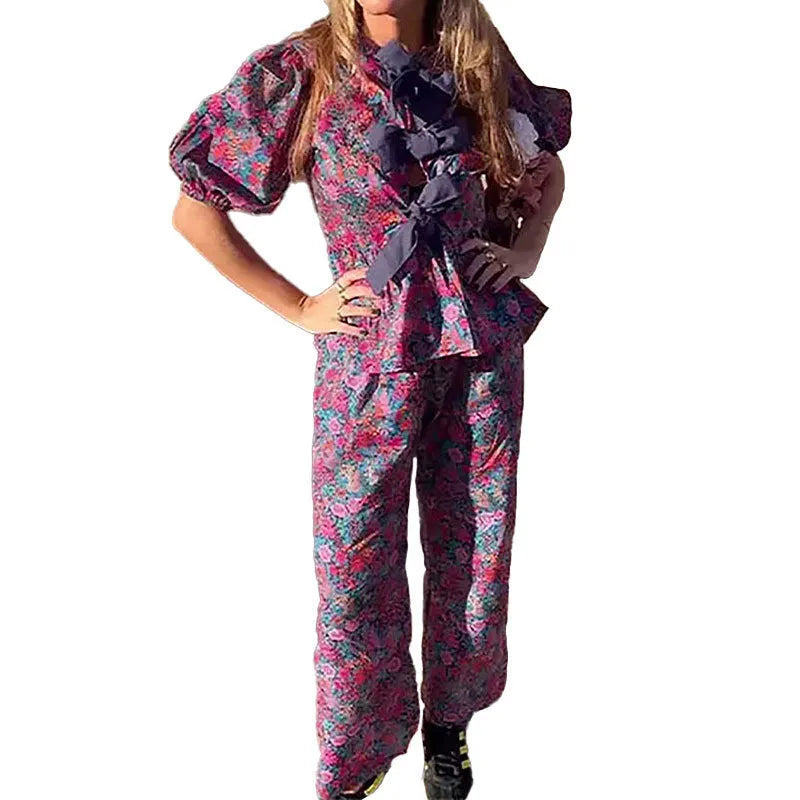 Floral printed women's trouser suit with puff sleeve top and tie-neck