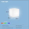 Modern square white LED cube light stool outdoors on a patio.