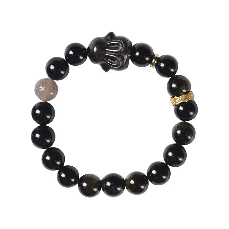 Handmade unisex lying rabbit Jin Yaoshi obsidian bracelet with gray agate and brass beads on neutral background