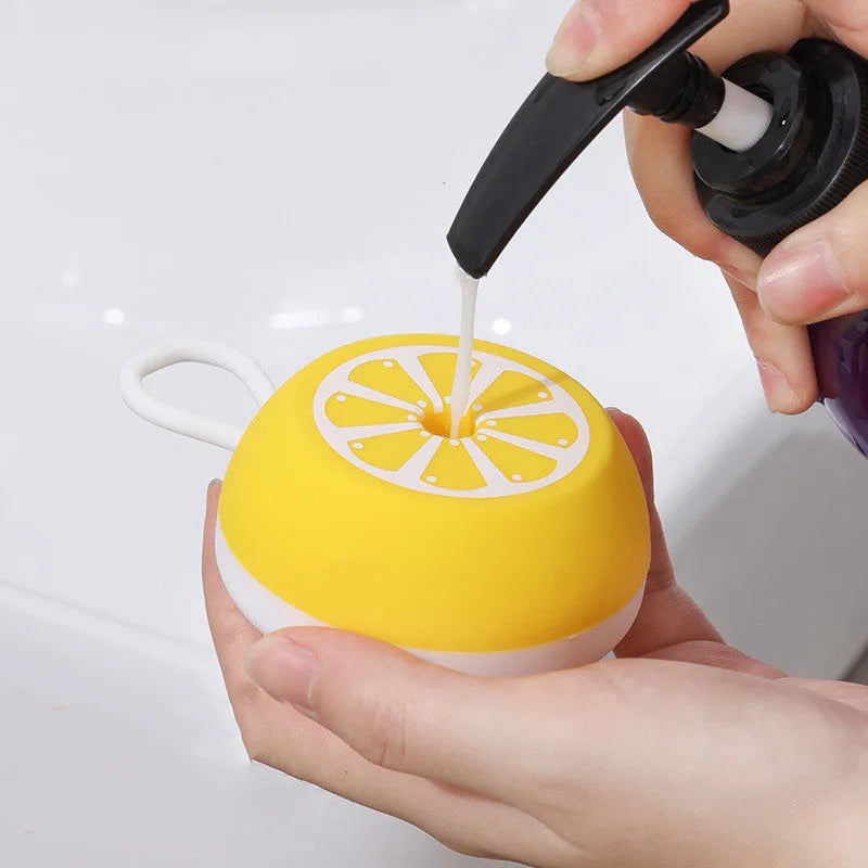 A soft silicone pet bath brush and massage comb in yellow, showing both the combed hair head and the 3D massage head.