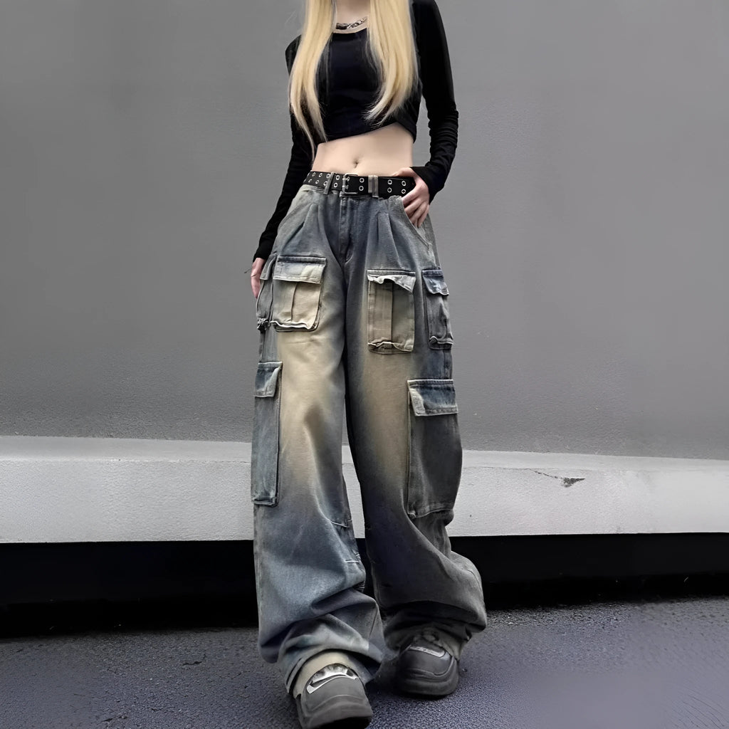 Man wearing loose fit light blue distressed jeans with multiple tooling pockets and straight leg silhouette.