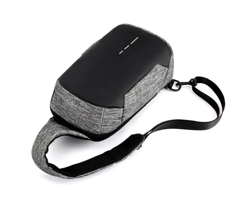Small dark blue oxford cloth waterproof chest bag with a single strap, shown with the zipper open.