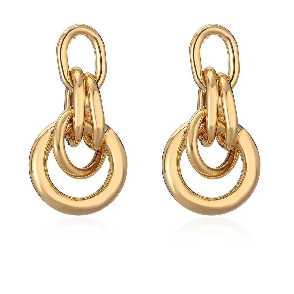 A pair of irregular geometric stud earrings in gold colour, made from copper.