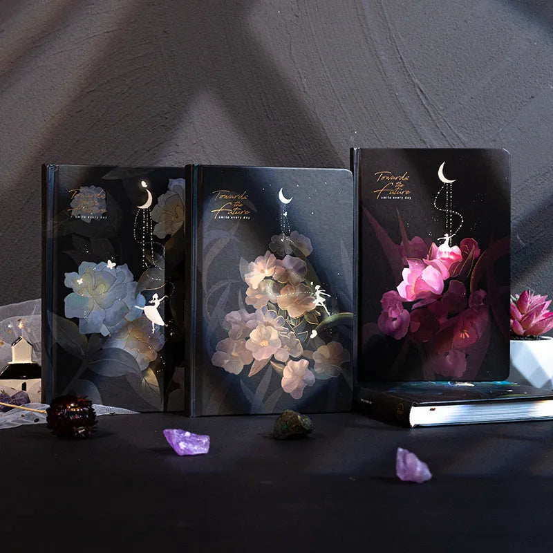 Four A5 hardcover notebooks with luminous covers in deep blue, gold, light blue, and purple colours.