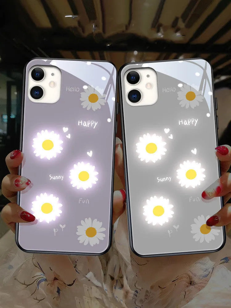 White TPU iPhone case with a painted purple daisy and letter design, showcasing its voice-activated luminous feature.