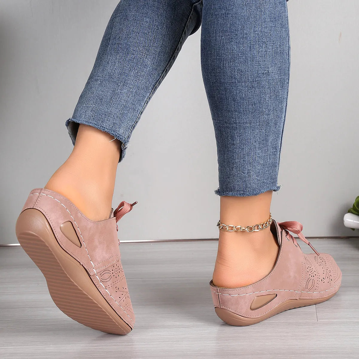 Women's black suede lace-up wedge slippers with a hollow out design and rubber sole.