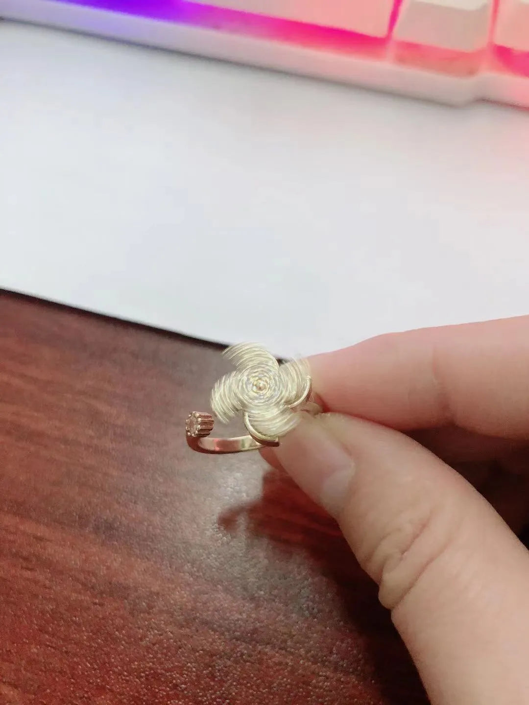 Rotating windmill design copper ring with gold electroplated finish showing geometric shape