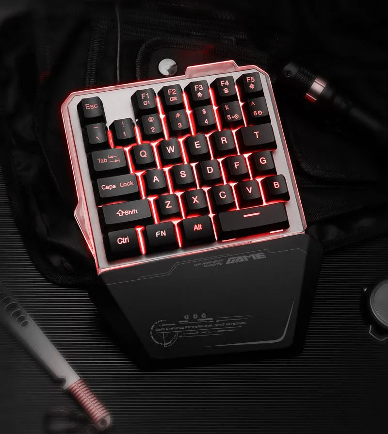 Black robotic one-handed mechanical keyboard with RGB backlighting on a desk