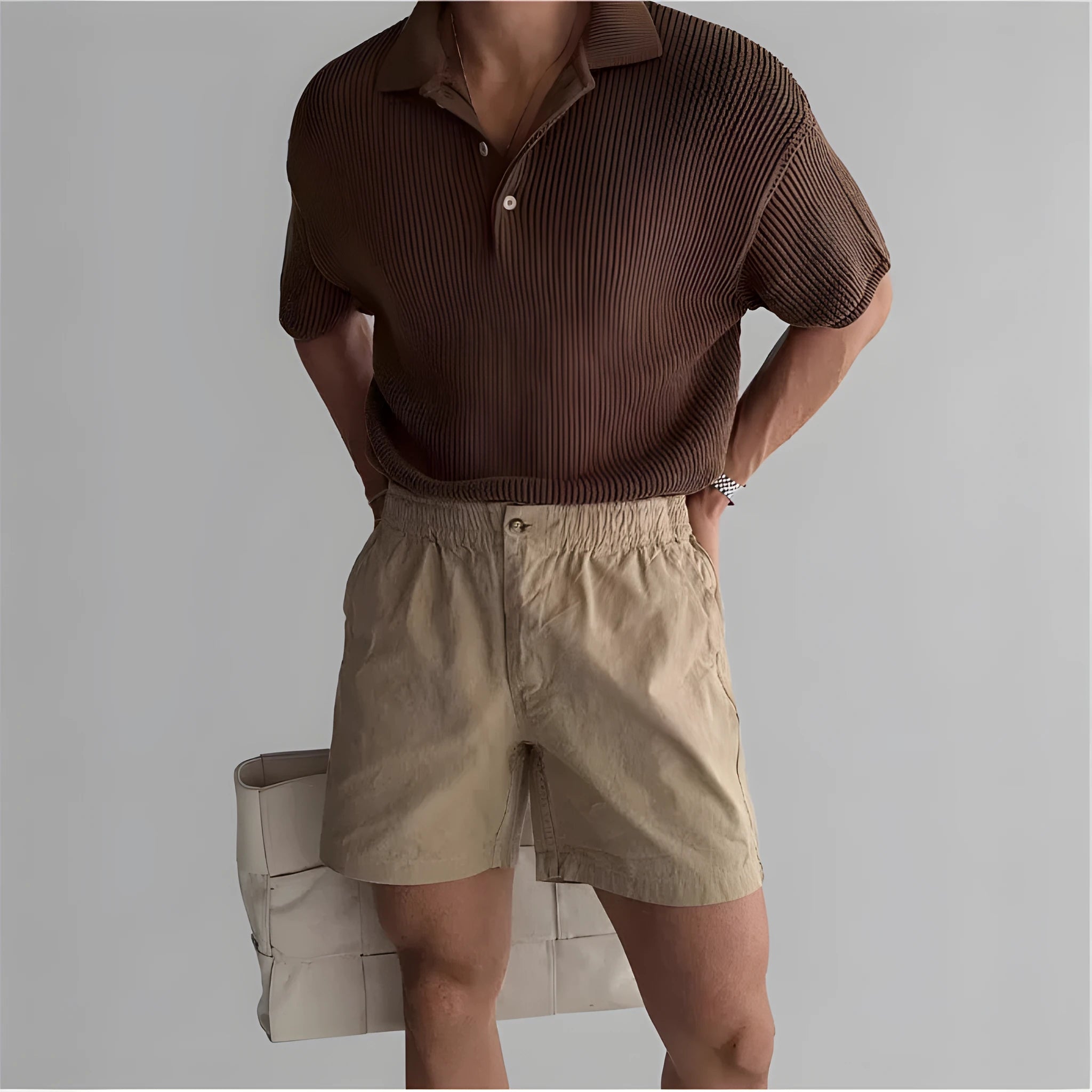 Men's loose-fit cotton sports shorts in black, shown on a hanger against a white background.