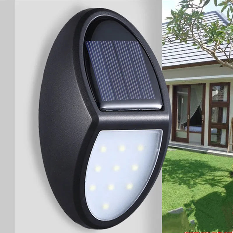 Black rectangular LED solar wall light for outdoor mounting with a solar panel on top.
