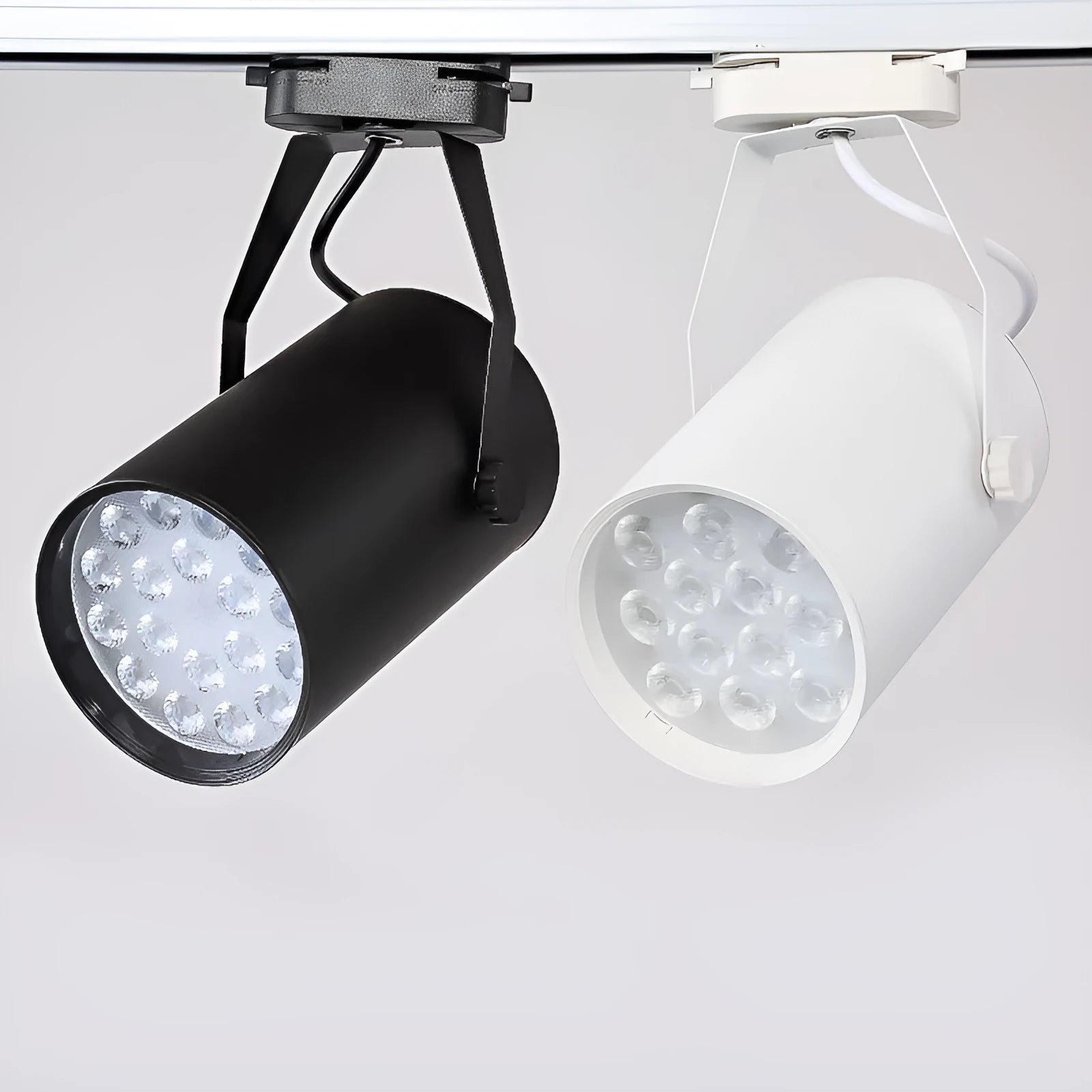 Black and white aluminium LED track spotlight on a lighting track for store display walls.