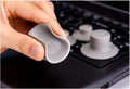 Grey durable plastic laptop cooling pads, two large and two small, on a desk next to a notebook