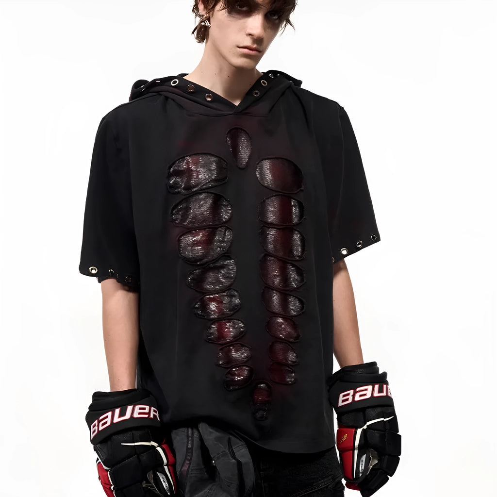 Man wearing a black hooded T-shirt covered in sequins, showing loose fit and short sleeves.